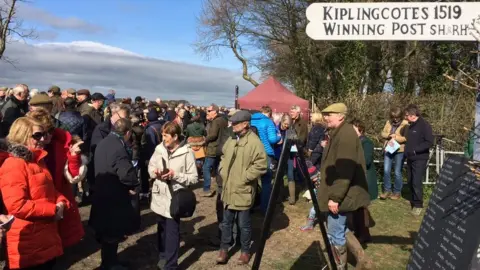 Spectators gathering on a countryside field