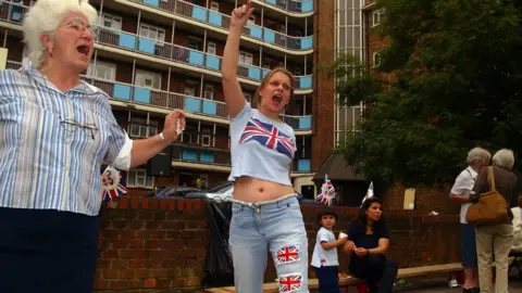 Getty Images A young woman with a union flag t-shirt and union flags on her jeans celebrates the Queen's 2002 Jubilee in London