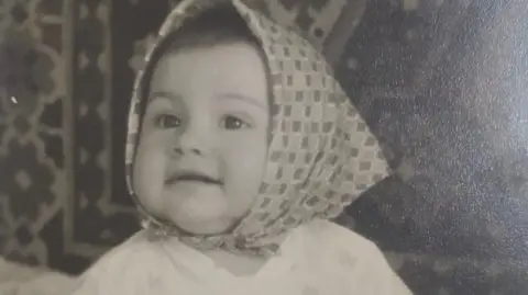 Lena Archbold  A picture of a little girl with a headscarf 