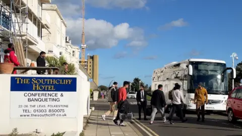 BBC Asylum seekers boarding a bus outside a hotel in Folkestone