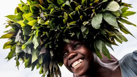 APRIL 01: A girl selling produce smiles in the Bulengo displacement camp on April 1, 2023 in Goma, Democratic Republic of Congo.