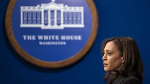 Reuters Kamala Harris stands alone near the White House seal