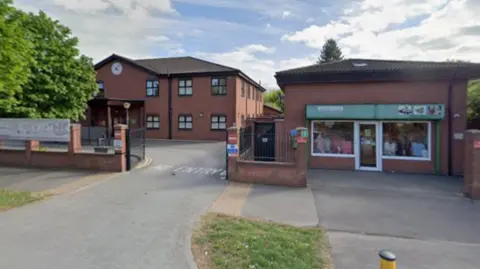 Google The front of the hospice - which has a charity shop adjoining.