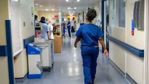 PA Media Nurse or doctor walking through hospital