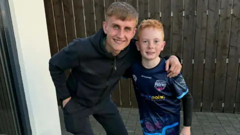 Mark Smith A man and young boy pose for a picture