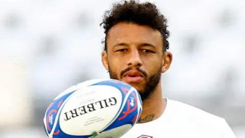 Reuters Courtney Lawes holding a rugby ball