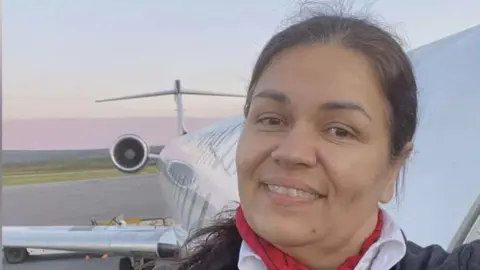 TVA Nouvelles Solange Tremblay taking a selfie outside of a plane