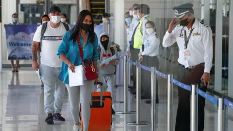 Reuters The first foreign tourists arrive at the airport as Phuket reopens to overseas tourists, allowing foreigners fully vaccinated against the coronavirus disease (COVID-19) to visit the resort island without quarantine, in Phuket, Thailand