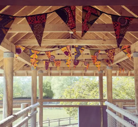 Zoological Society of East Anglia African themed bunting made by local resident, Carol Williamson, to decorate the lion enclosure, at Africa Live, Suffolk