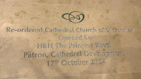 A stone which reads re-ordered Cathedral Church of St German Opened by The Princess Royal, Patron, Cathedral Development, 17th October 2024.