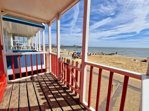  Juliet Davis The view from a beach hut looking out on to a sandy beach