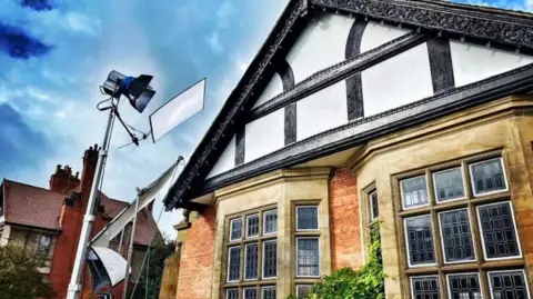 Wirral Globe Film lighting outside Hulme Hall in Port Sunlight