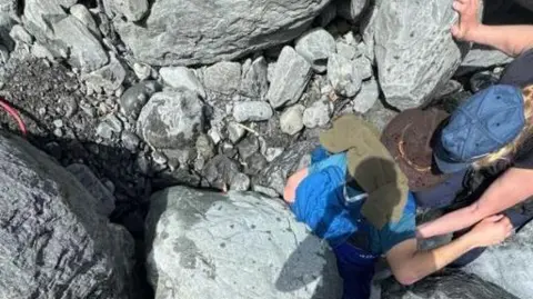 The rock on top of the man in the creek