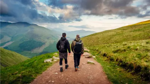 Getty Images Men hiking