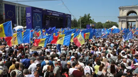 Reuters Moldovans wave EU flags during a pro-European rally in Chisinau on Sunday