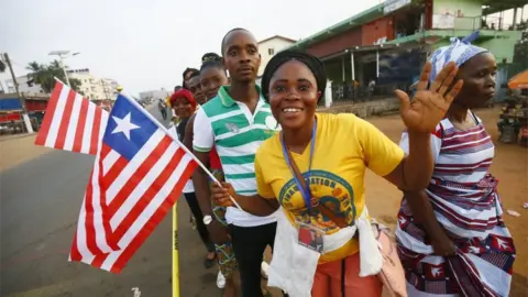 EPA Liberians cheer as they stand in line to enter the inauguration off the President-elect, George Weah, at the Samuel Kanyon Doe stadium, in Monrovia, Liberia, 22 January 2018.