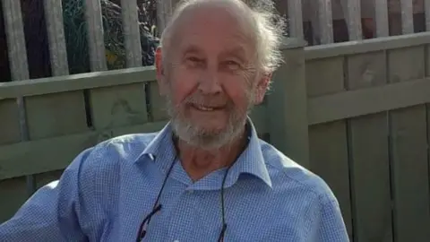 JANE STEVENSON David Barber, a balding man with a grey beard, smiling. He is wearing a blue check shirt.