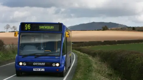 PA Media A rural bus on a road in Shropshire