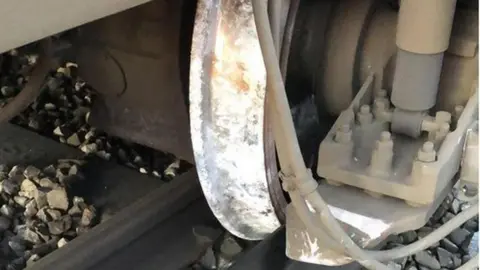 Network Rail The front wheels of a train shown next to railway lines