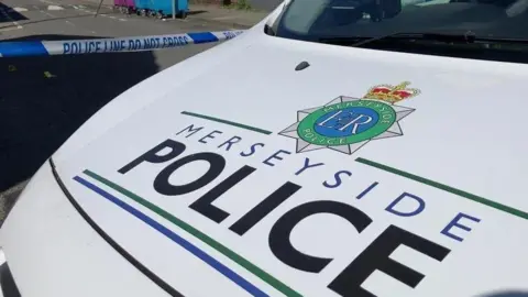 The bonnet of a police car bearing the livery of Merseyside Police