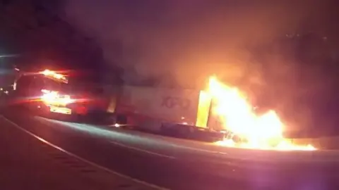 Burning lorry and a fire engine