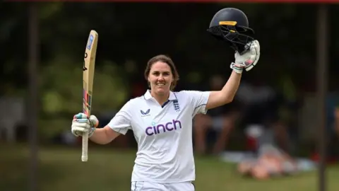 Nat Sciver-Brunt raising her bat