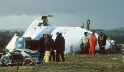 Reuters Emergency service workers gathered next to the wreckage of Pan Am flight 103, in a farmer's field east of Lockerbie