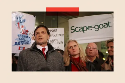 Getty Images Andrew Wakefield, in a grey jumper, addresses a crowd