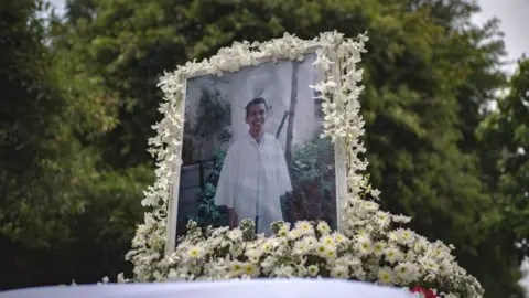 Getty Images A photo of Kian Delos Santos, 17, on top of the hearse during his funeral on August 26, 2017