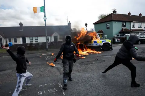 Reuters Young hooded men throw a petrol bomb at a police vehicle in Londonderry