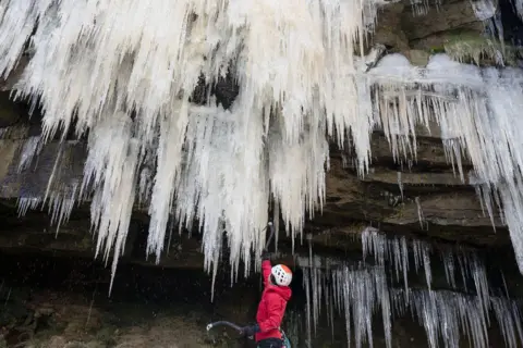 Rod Kirkpatrick/RKP Photography A group of climbers useing specialised equipment to climb the frozen Kinder Downfall waterfall