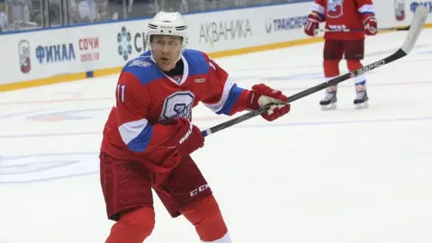 Getty Images Putin playing ice hockey in Sochi, 2019