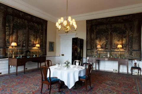 David Cheskin/Royal Collection Enterprises Limited 2026 Image of the Royal Breakfast Room, the room is decorated with tapestries and a dinning table.