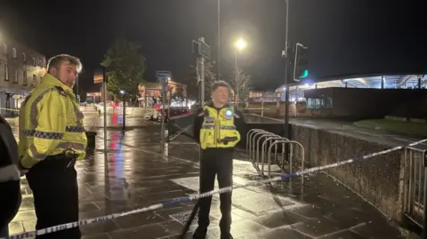 Two police officers stand guard by the cordon in Chester.