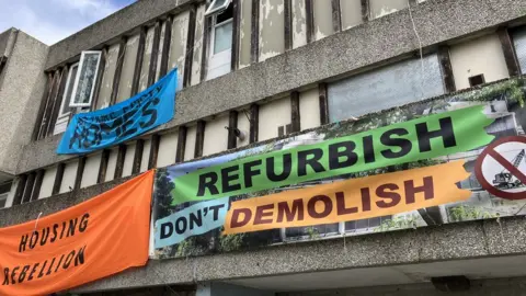 Joe Coughlan  protest banners on the estate