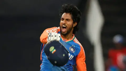 India batter Tilak Varma roars in celebration after hitting a century in a T20 against South Africa