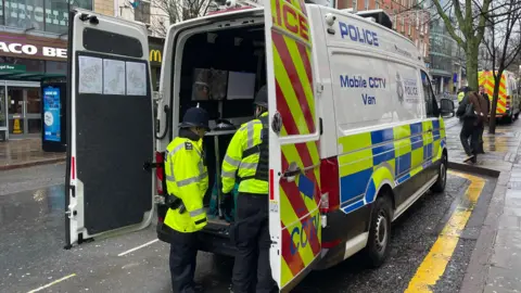 Police officers around the back of a van in Nottingham city centre