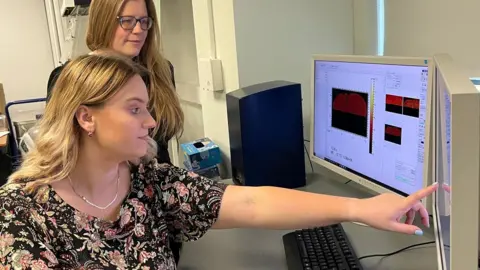 Supplied Madeline Berrow and Dr Felicity De Cogan reviewing test results on a computer screen.
