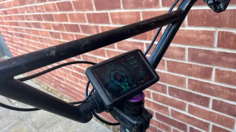Clare Worden/BBC Close-up shot of the display for an illegally modified e-bike. It measures 92mph when the legal limit is 15.5mph.