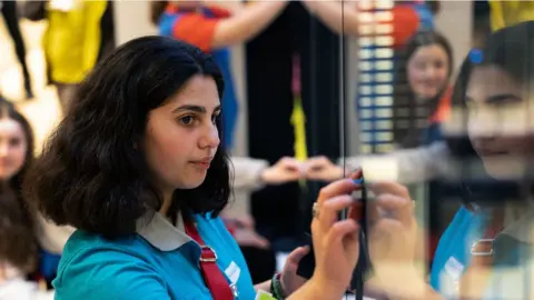 Girlguiding A Ranger trying out technology