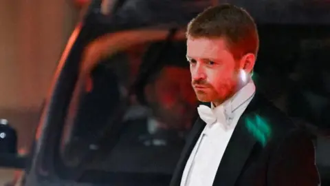 Reuters Morgan McSweeney wearing a black jacket, white shirt and white bow tie.