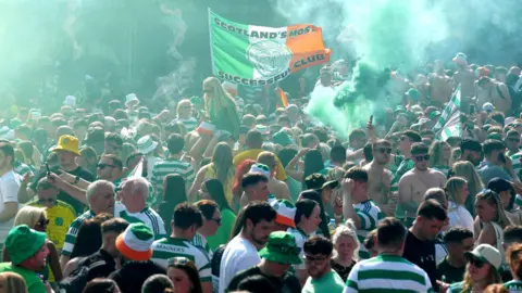 Celtic fans let off smoke bombs after gathering in the Trongate area after the match