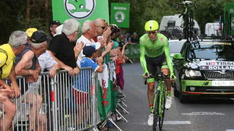 Getty Images A cyclist being cheered by Welsh fans in the 2016 Tour de France in Sallanches - Megeve in the french Alps, France. 