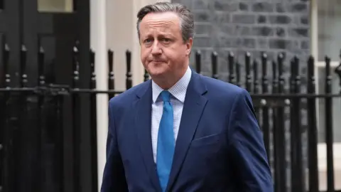 PA Media Lord David Cameron leaves 10 Downing Street during his time as foreign secretary