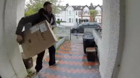 A parcel being carried away from a doorstep 