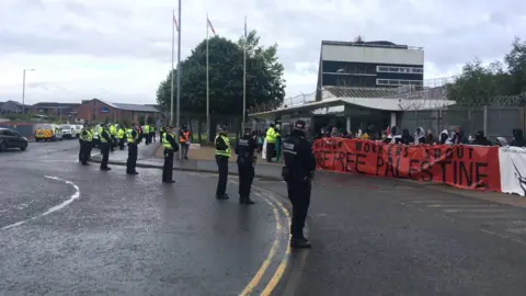 Activists and police outside the factory in Govan