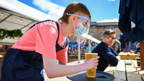 Getty Images Barman serving pint at SWG3 beer garden in Glasgow