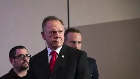 Getty Images BIRMINGHAM, AL - NOVEMBER 16: Republican candidate for U.S. Senate Judge Roy Moore listens to a question during a news conference