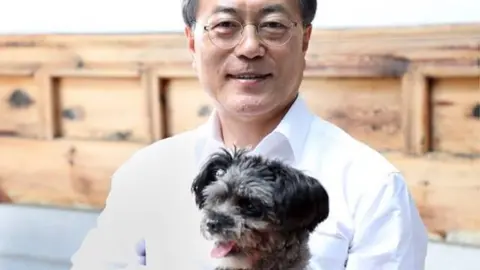 Cheong Wa Dae handout South Korean President Moon Jae-in with his new dog Tory