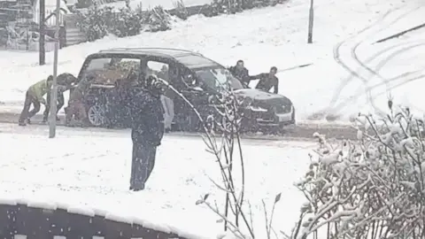 Michelle Mulcahy Hearse being pushed through snow